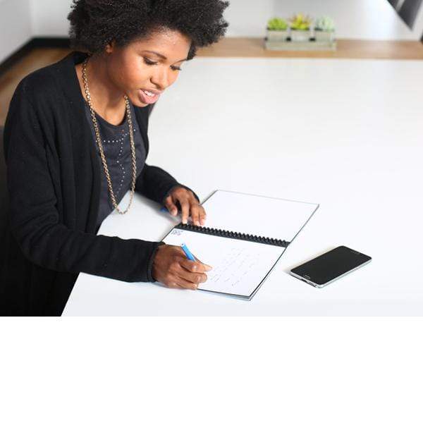 woman writing in the Core notebook