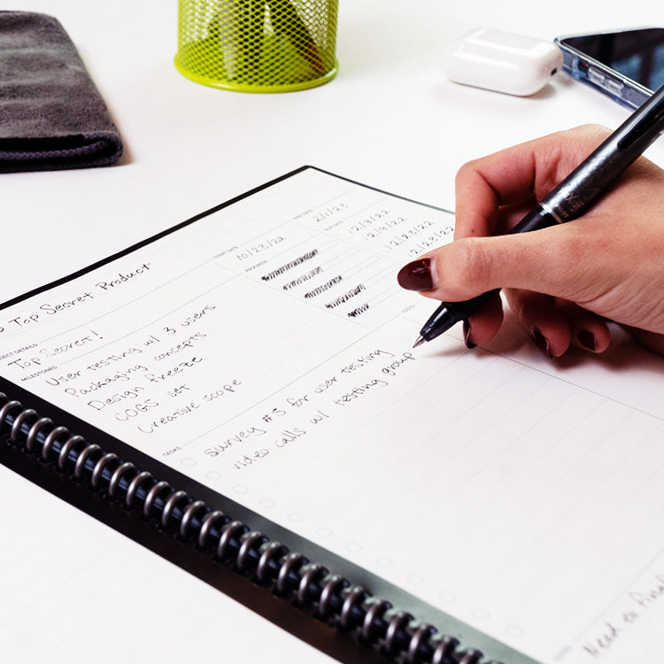 person writing in the Rocketbook Fusion Plus