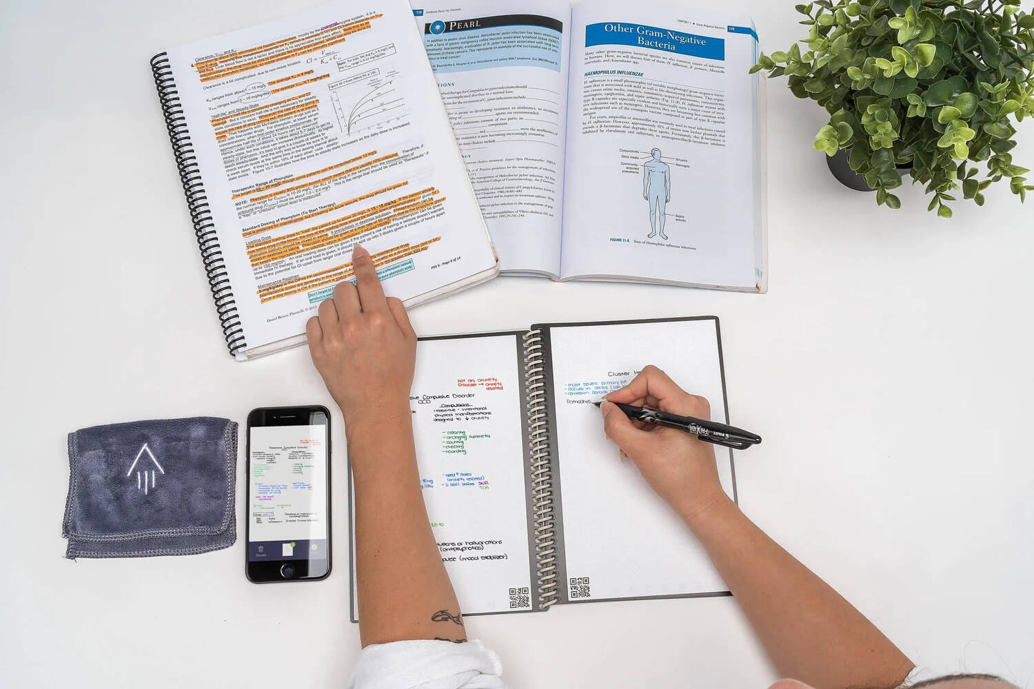 person writing in Rocketbook notebook