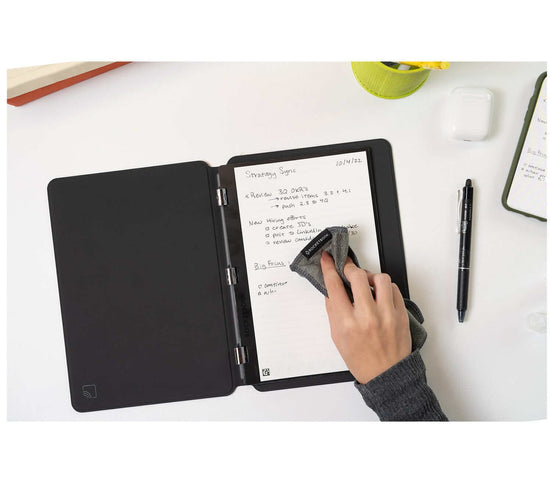 person wiping writing away in Rocketbook Pro