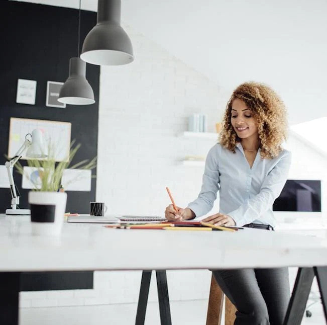 woman writing in Rocketbook Wave notebook