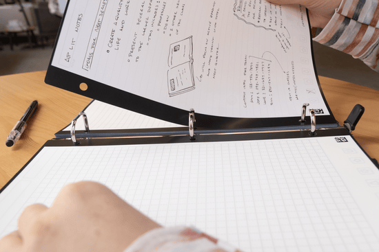 individual taking filler paper out of a binder
