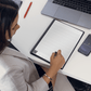 woman writing on Rocketbook Matrix graph paper page
