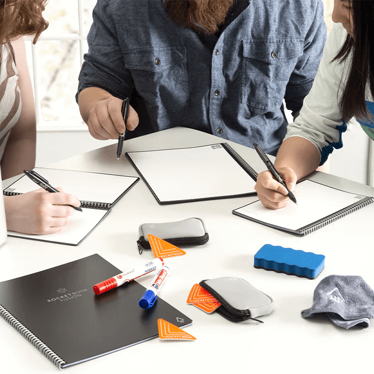 a group of people taking notes in Rocketbook notebooks